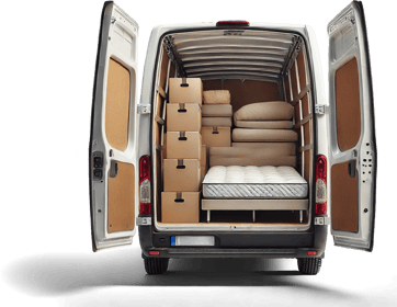 A van with its rear doors open, revealing an organized interior filled with stacked cardboard boxes, a mattress, sofa cushions, and small furniture pieces.